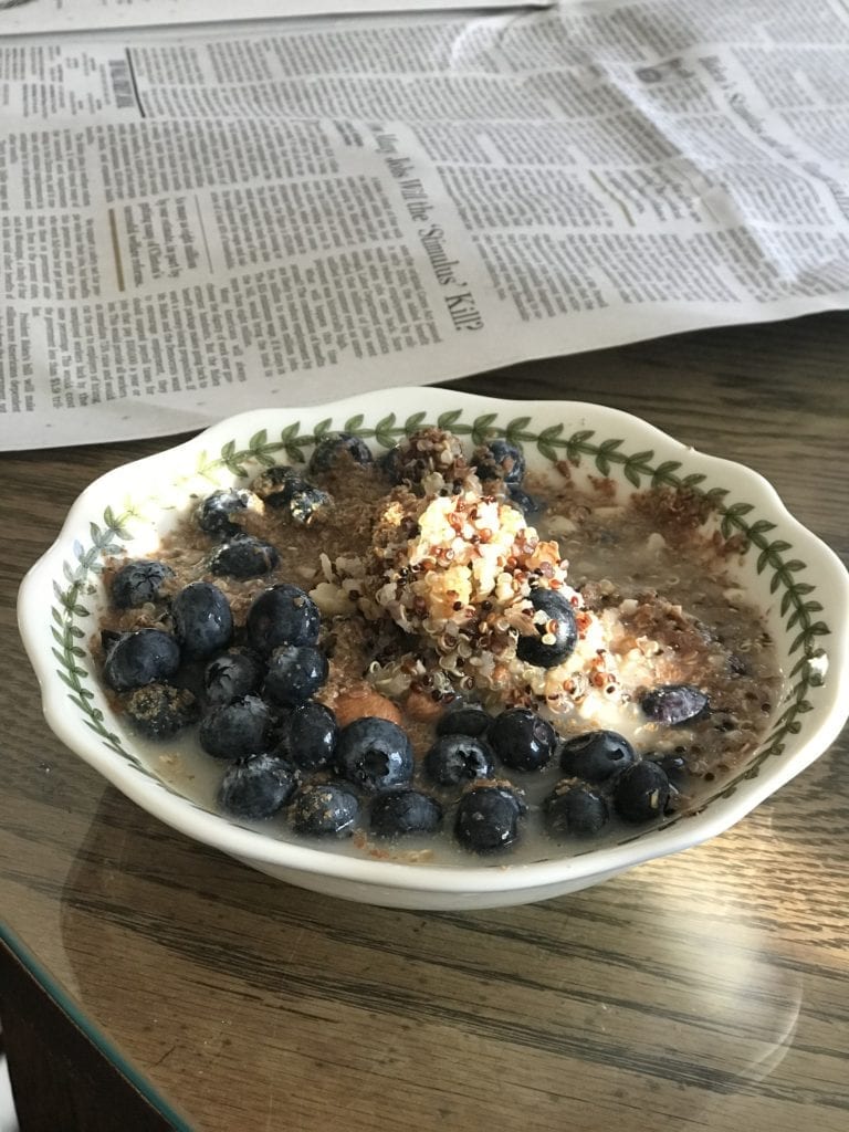 bowl of quinoa, almonds, flax seed, blueberries and almond milk